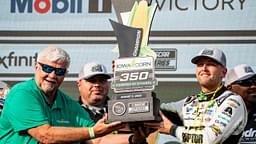 William Byron (24) raises a trophy after the NASCAR Cup Series Iowa Corn 350 on Aug. 3, 2025, at Iowa Speedway in Newton, Iowa. Byron (24) finished the race first.