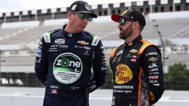 NASCAR Cup Series driver Kyle Busch (left) talks with driver Austin Dillon (right) on pit road during practice and qualifying for The Great American Getaway 400 at Pocono Raceway.