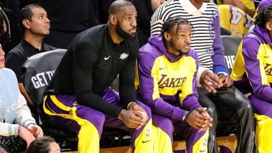 Los Angeles Lakers forward LeBron James (23) and son Los Angeles Lakers guard Bronny James (9) watch from the bench during the Minnesota Timberwolves vs Los Angeles Lakers game