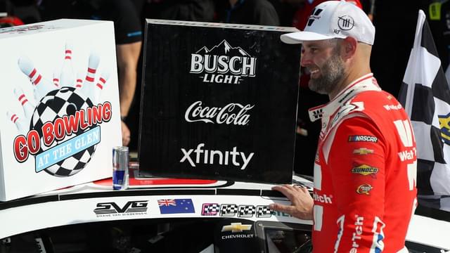 NASCAR Cup Series driver Shane Van Gisbergen applies the winner’s sticker to his car in victory lane after winning the Go Bowling at The Glen at Watkins Glen International.