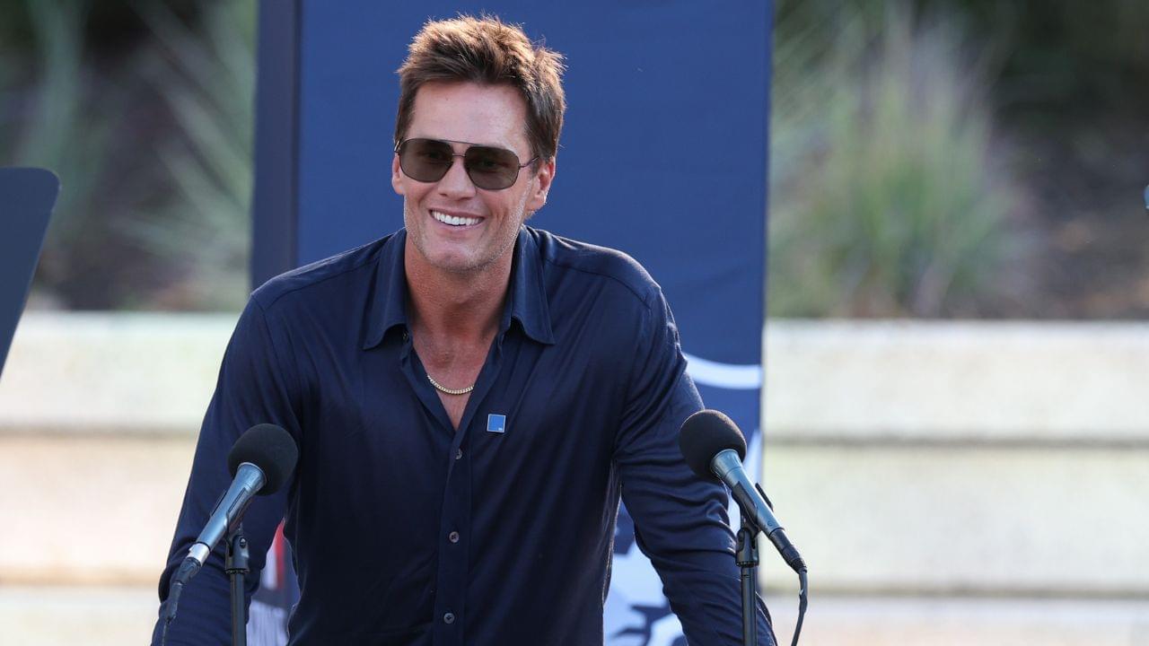 Retired New England Patriot Hall of Famer Tom Brady speaks during a statue unveiling before a game against the Washington Commanders at Gillette Stadium.