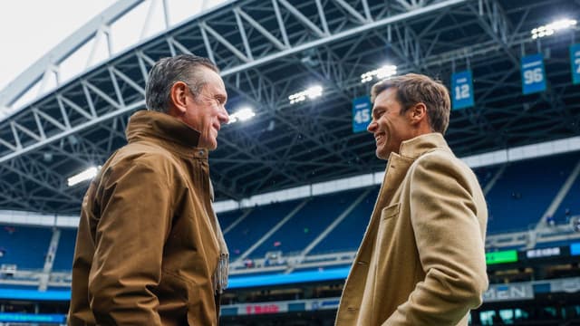 Former New England Patriots quarterbacks Drew Bledsoe, left, and Tom Brady, right, talk during pregame warmups between the Seattle Seahawks and Buffalo Bills at Lumen Field.