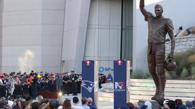 Retired New England Patriot Hall of Famer Tom Brady speaks during a statue unveiling before a game against the Washington Commanders at Gillette Stadium.