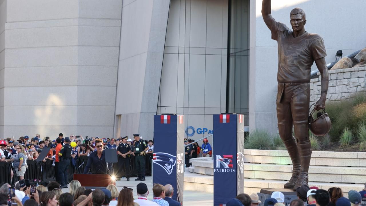 Retired New England Patriot Hall of Famer Tom Brady speaks during a statue unveiling before a game against the Washington Commanders at Gillette Stadium.
