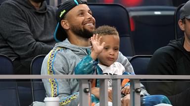 Jul 2, 2022; San Francisco, CA, USA; Golden State Warriors guard Stephen Curry (30) sits in the stands with son Canon during the second quarter against the Sacramento Kings at the California Summer League at Chase Center