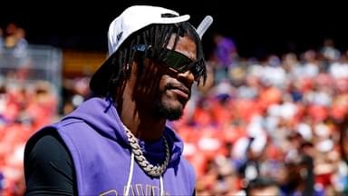 Baltimore Ravens quarterback Lamar Jackson (8) walks on the field before the game against the Washington Commanders at Northwest Stadium.