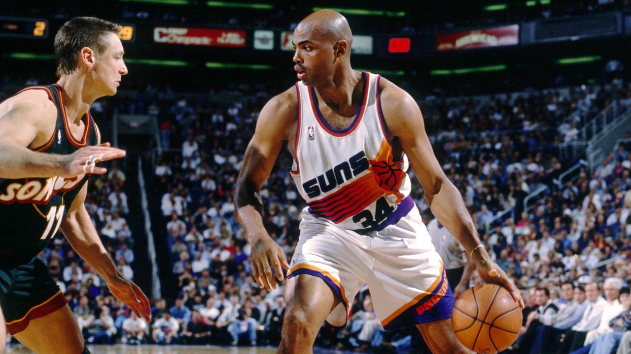 Phoenix Suns forward Charles Barkley (34) is defended by Seattle Supersonics forward Detlef Schrempf (11) at America West Arena.