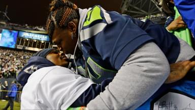 Seattle Seahawks running back Marshawn Lynch (left) kisses his mother Delisa Lynch (right) after the 2013 NFC Championship football game against the San Francisco 49ers at CenturyLink Field.