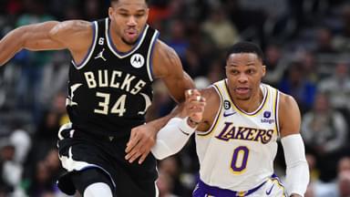 Dec 2, 2022; Milwaukee, Wisconsin, USA; Milwaukee Bucks forward Giannis Antetokounmpo (34) races down the court with Los Angeles Lakers guard Russell Westbrook (0) at Fiserv Forum.