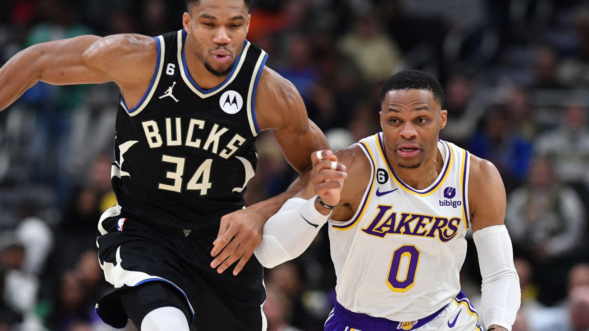 Dec 2, 2022; Milwaukee, Wisconsin, USA; Milwaukee Bucks forward Giannis Antetokounmpo (34) races down the court with Los Angeles Lakers guard Russell Westbrook (0) at Fiserv Forum.