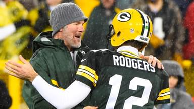 Green Bay Packers former quarterback Brett Favre hugs Green Bay Packers quarterback Aaron Rodgers (12) at half time for a NFL game against the Chicago Bears on Thanksgiving at Lambeau Field.
