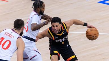 Devin Booker 1 of the Phoenix Suns fends off Derrick Jones Jr. 55 of the Los Angeles Clippers during their regular season NBA
