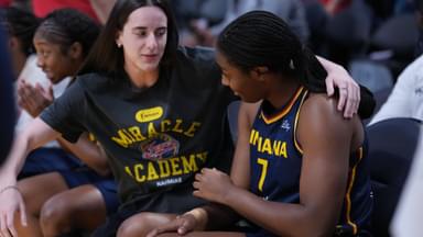 Aug 5, 2025; Los Angeles, California, USA; Indiana Fever guard Caitlin Clark (22) gives a hug to forward Aliyah Boston (7) in the first half against the LA Sparks at Crypto.com Arena.