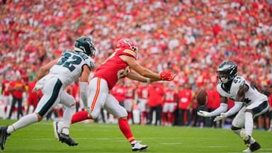 Philadelphia Eagles safety Andrew Mukuba (24) intercepts a pass intended for Kansas City Chiefs tight end Travis Kelce (87) during the fourth quarter of the game at GEHA Field at Arrowhead Stadium.