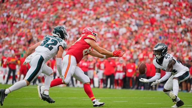 Philadelphia Eagles safety Andrew Mukuba (24) intercepts a pass intended for Kansas City Chiefs tight end Travis Kelce (87) during the fourth quarter of the game at GEHA Field at Arrowhead Stadium.