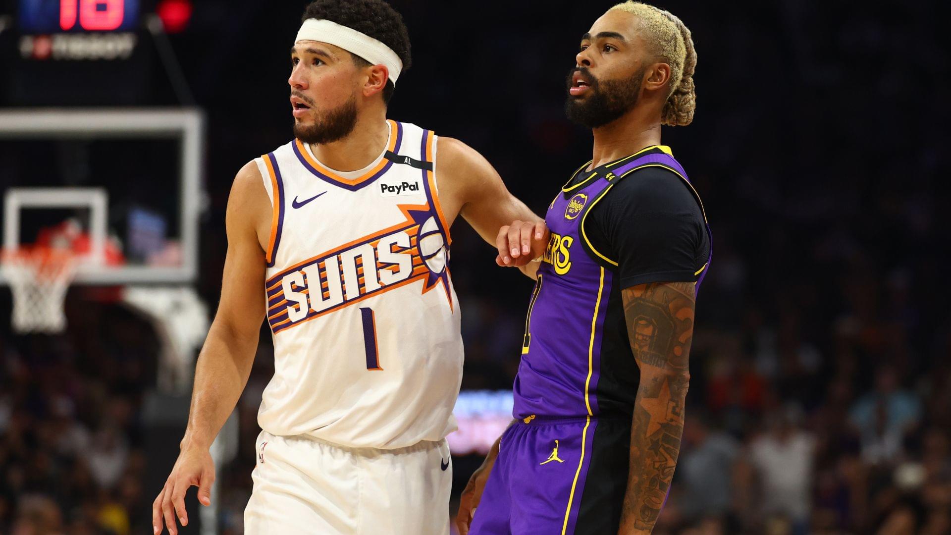 Oct 28, 2024; Phoenix, Arizona, USA; Los Angeles Lakers guard D'Angelo Russell (right) against Phoenix Suns guard Devin Booker at Footprint Center.
