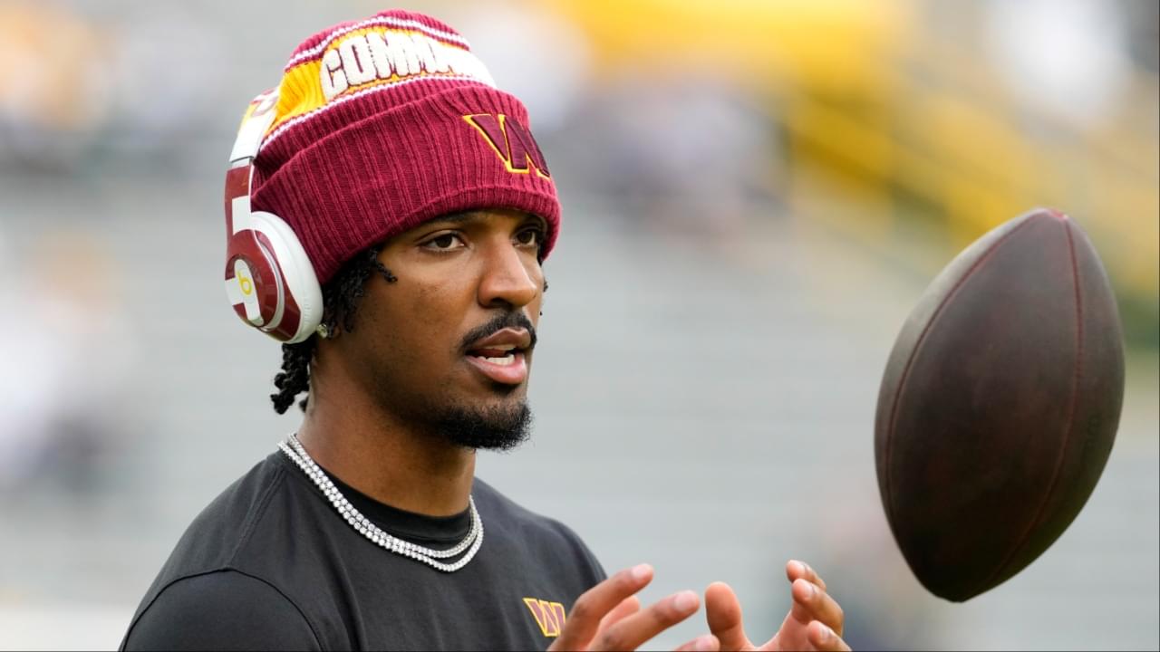 Washington Commanders quarterback Jayden Daniels (5) warms up before a game against the Green Bay Packers at Lambeau Field.