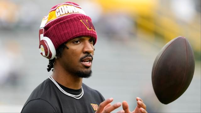 Washington Commanders quarterback Jayden Daniels (5) warms up before a game against the Green Bay Packers at Lambeau Field.