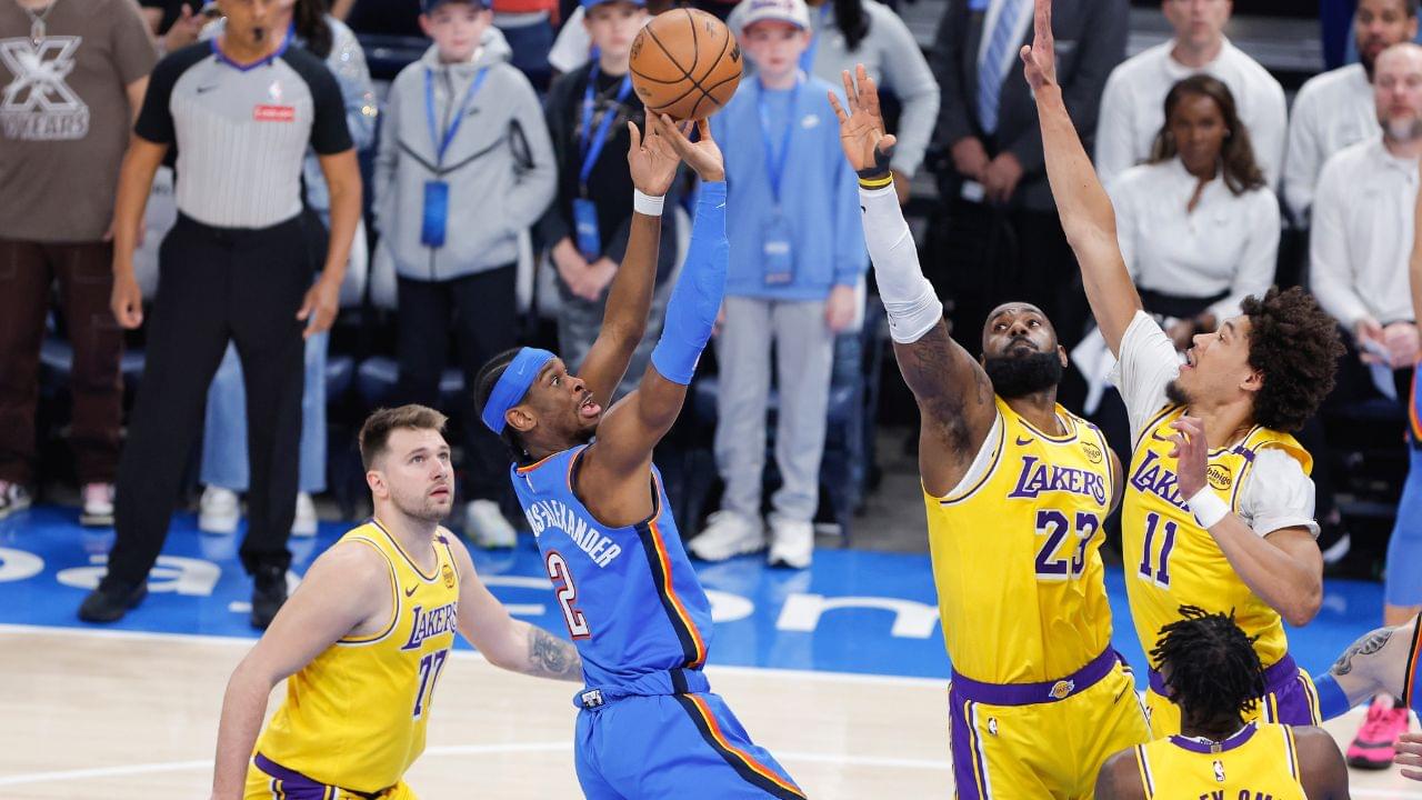 Oklahoma City Thunder guard Shai Gilgeous-Alexander (2) shoots as Los Angeles Lakers forward LeBron James (23) and center Jaxson Hayes (11) defend the shot during the first quarter at Paycom Center.