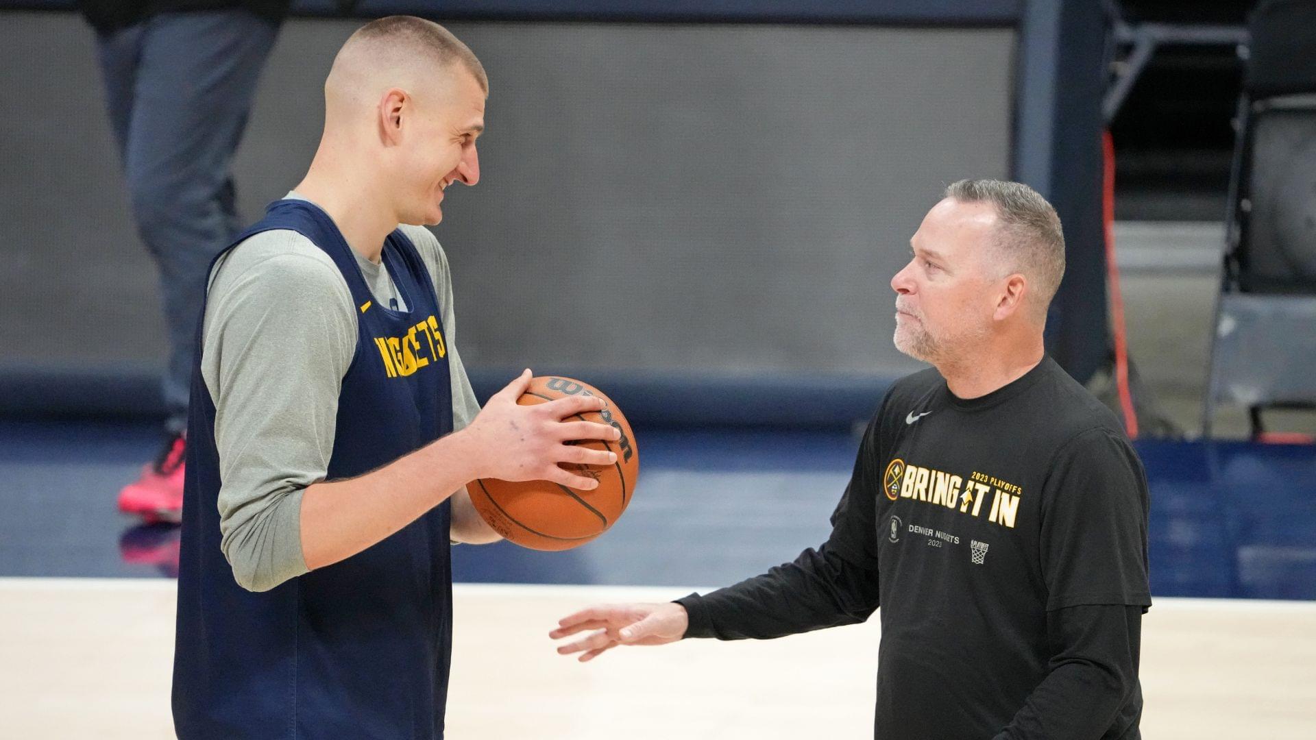 May 31, 2023; Denver, CO, USA; Denver Nuggets center Nikola Jokic (15) talks with head coach Michael Malone during a practice session on media day before the 2023 NBA Finals at Ball Arena.