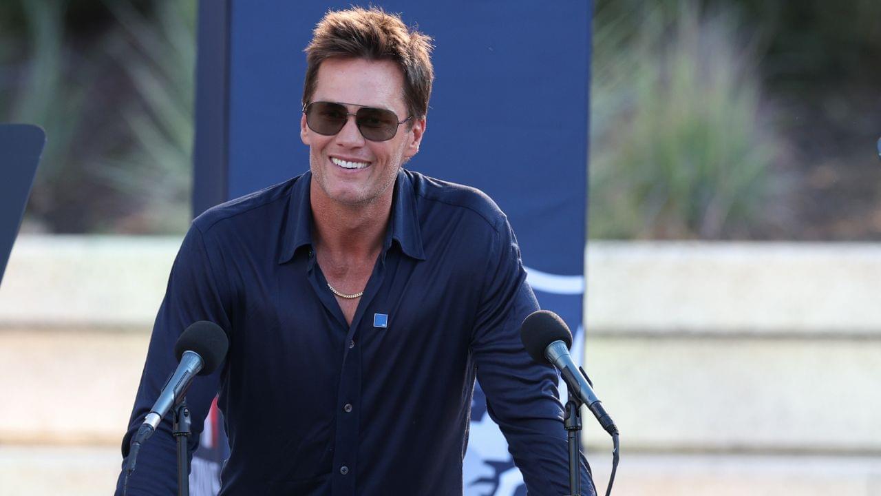 Retired New England Patriot Hall of Famer Tom Brady speaks during a statue unveiling before a game against the Washington Commanders at Gillette Stadium.