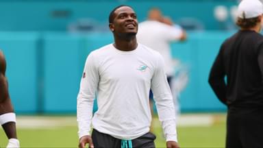 Miami Dolphins tight end Julian Hill (89), wide receiver Tyreek Hill (10), running back De'Von Achane (28), and wide receiver Jaylen Waddle (17) look on from the field before a preseason game against the Washington Commanders at Hard Rock Stadium.
