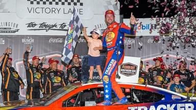 Aug 31, 2025; Darlington, South Carolina, USA; NASCAR Cup Series driver Chase Briscoe (19) and his son Brooks celebrates his win at the Cook Out Southern 500 at Darlington Raceway.