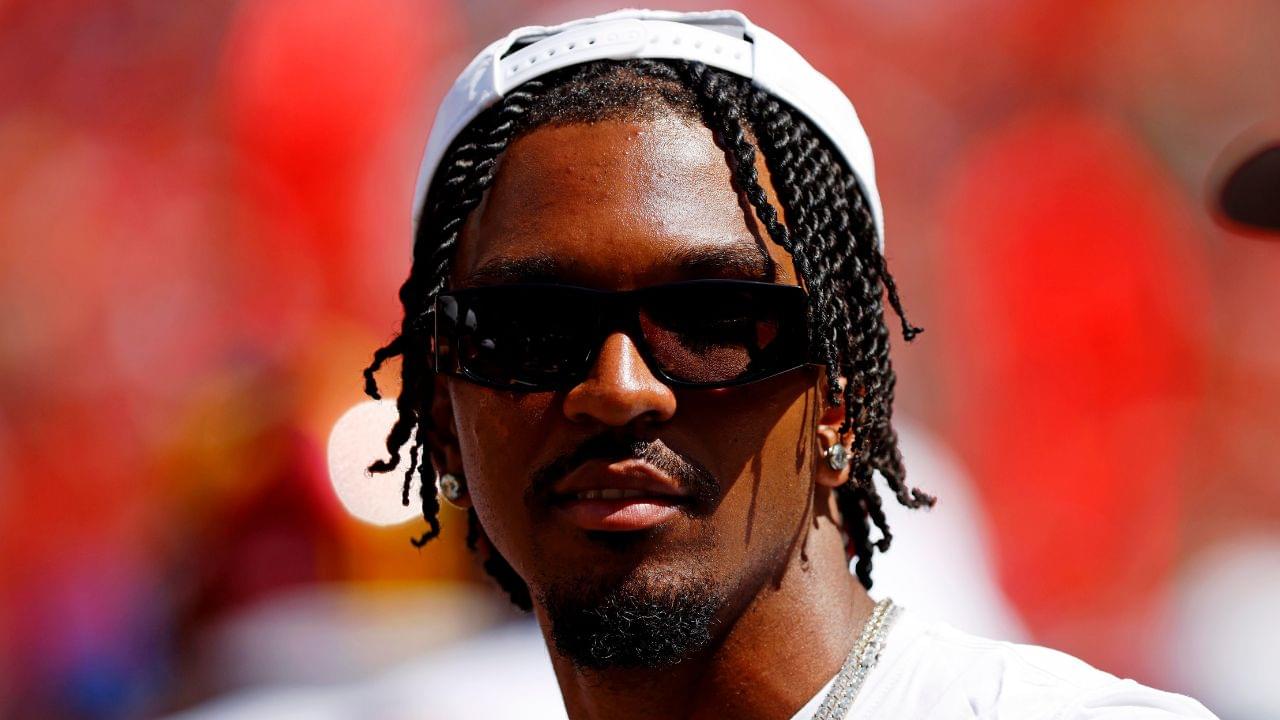 Washington Commanders quarterback Jayden Daniels (5) looks on from the sidelines during the game against the Baltimore Ravens at Northwest Stadium.