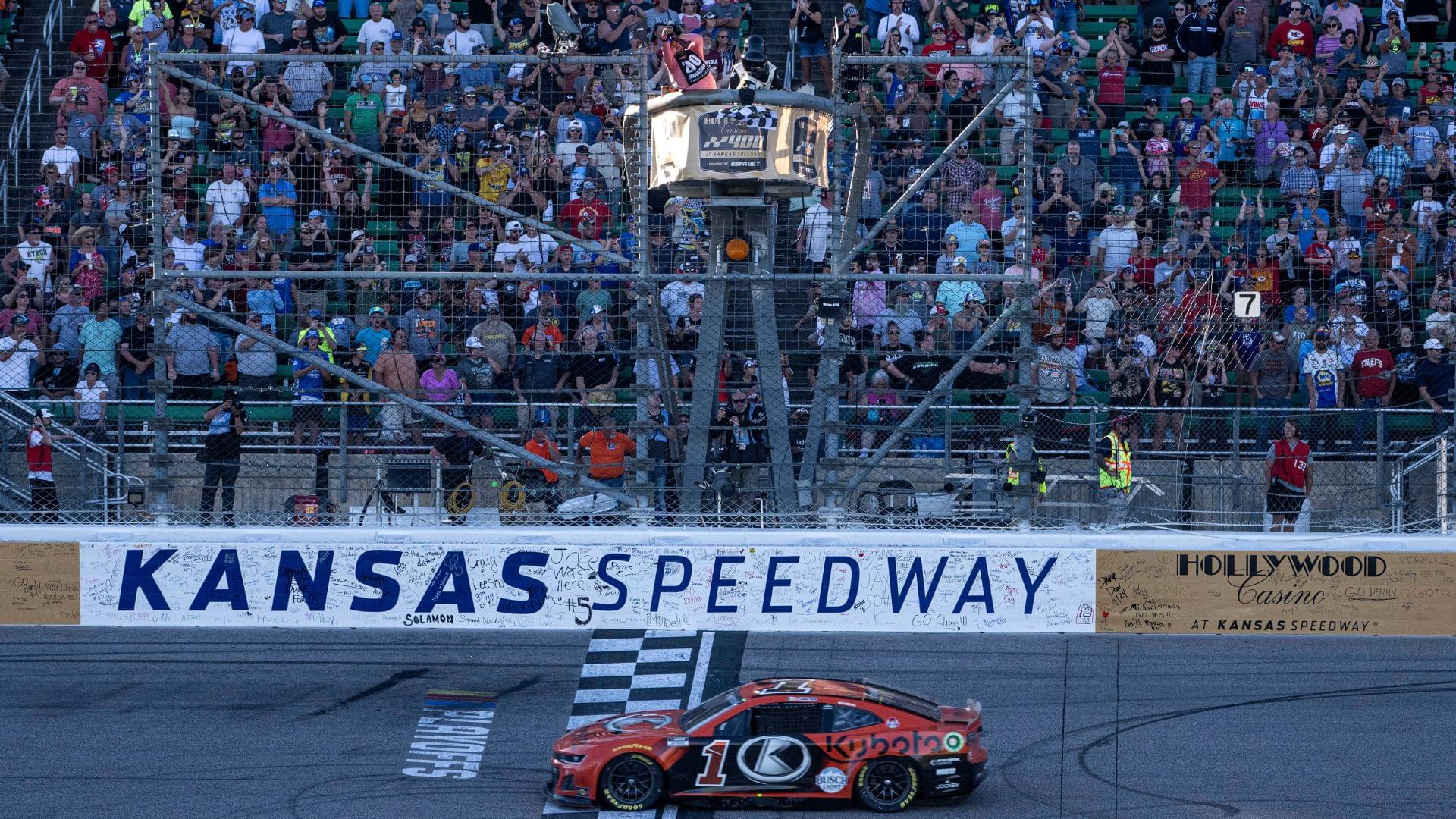 Sep 29, 2024; Kansas City, Kansas, USA; NASCAR Cup Series driver Ross Chastain (1) crosses the finish line to win the Hollywood Casino 400 at Kansas Speedway.
