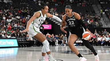 Las Vegas Aces center A'ja Wilson (22) drives past Minnesota Lynx forward Napheesa Collier (24) in the first quarter of their game at T-Mobile Arena.