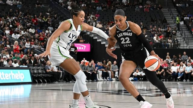 Las Vegas Aces center A'ja Wilson (22) drives past Minnesota Lynx forward Napheesa Collier (24) in the first quarter of their game at T-Mobile Arena.