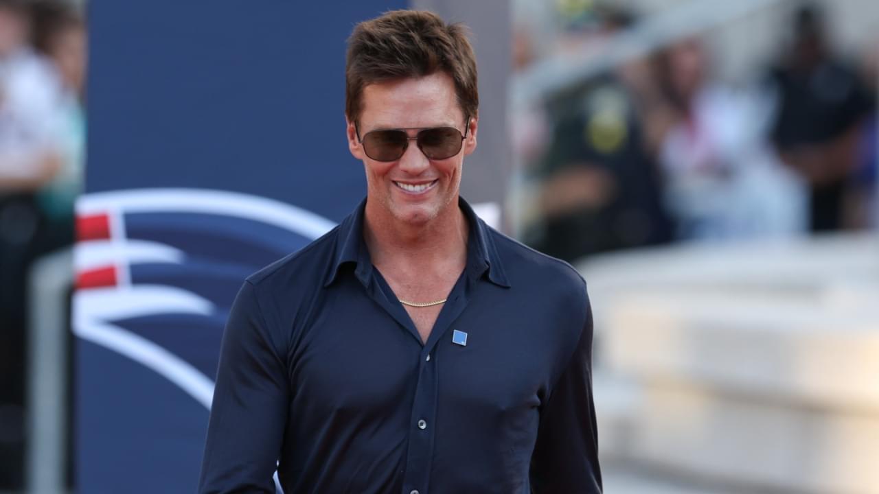 Retired New England Patriot Hall of Famer Tom Brady speaks during a statue unveiling before a game against the Washington Commanders at Gillette Stadium.
