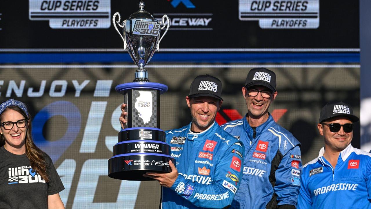 NASCAR Cup Series driver Denny Hamlin (11) hosts the trophy after winning the Enjoy Illinois 300 at World Wide Technology Raceway.