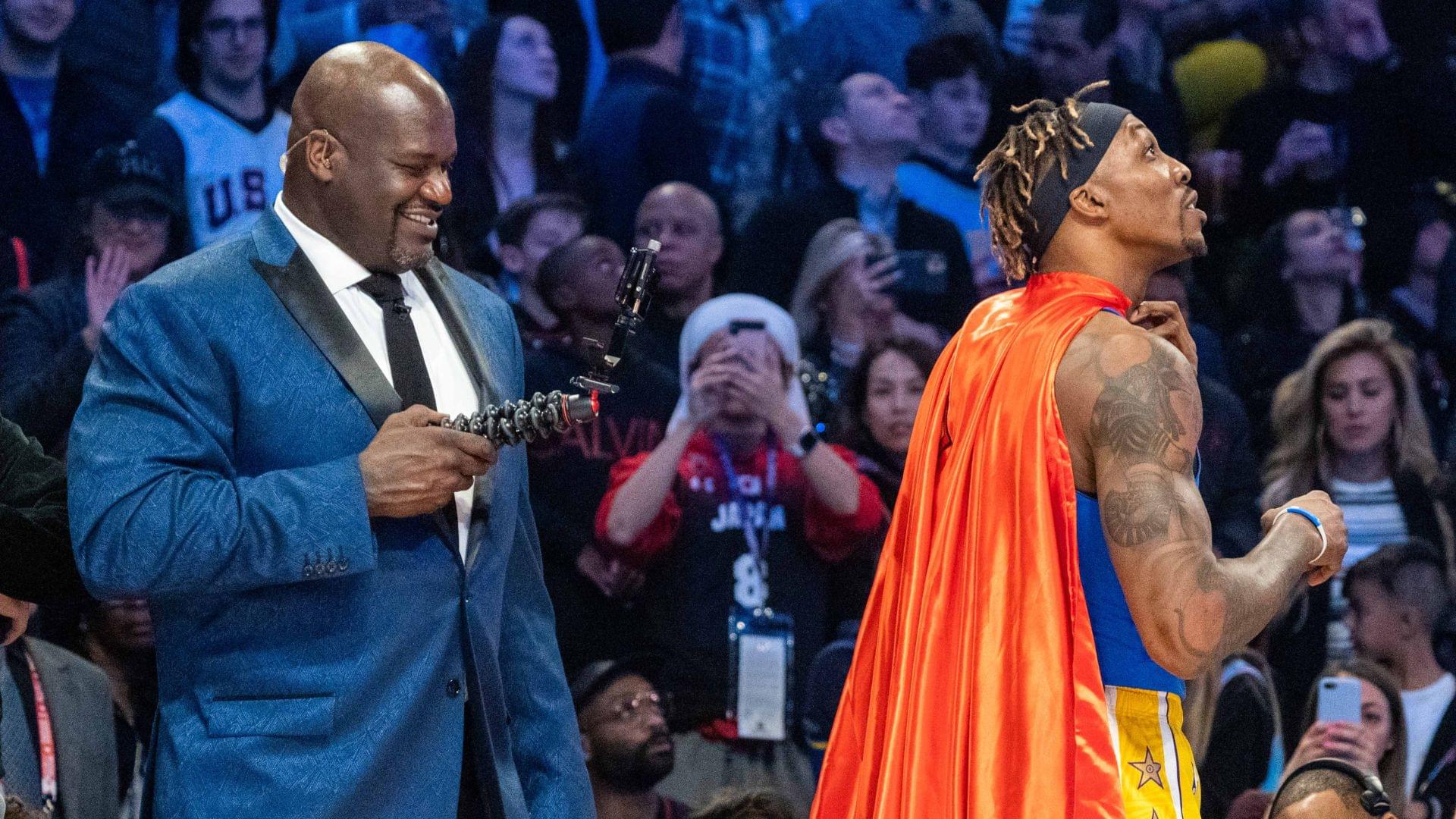 February 15, 2020; Chicago, Illinois, USA; NBA great Shaquille O'Neal (left) videotapes Los Angeles Lakers player Dwight Howard (right) in a Superman costume dedicated to the late Los Angeles Lakers great Kobe Bryant during NBA All Star Saturday Night at United Center.