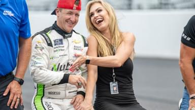 Jul 30, 2022; Speedway, Indiana, USA; NASCAR Xfinity Series driver AJ Allmendinger (16) and his wife Tara Meador have a laugh after winning the Penzoil 150 at the Indianapolis Motor Speedway Road Course
