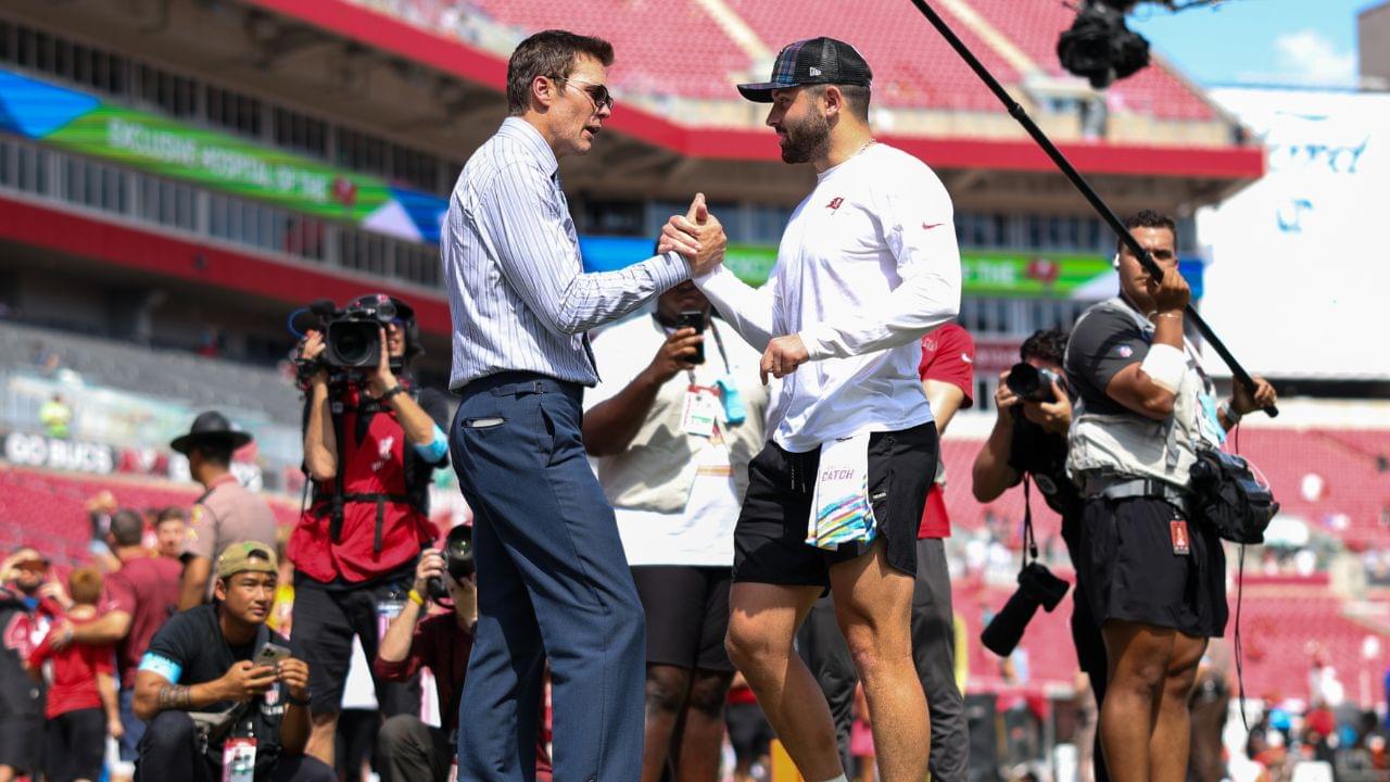 Fox NFL broadcaster and former NFL quarterback Tom Brady speaks to Tampa Bay Buccaneers quarterback Baker Mayfield (6) before a game against the Philadelphia Eagles at Raymond James Stadium.