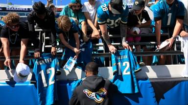 Jacksonville Jaguars wide receiver Travis Hunter (12) signs autographs before an NFL football matchup, Sunday, Oct. 12, 2025, at EverBank Stadium in Jacksonville, Fla. The Seahawks defeated the Jaguars 20-12.