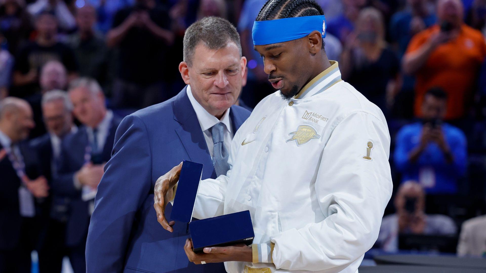 Oct 21, 2025; Oklahoma City, Oklahoma, USA; Oklahoma City Thunder guard Shai Gilgeous-Alexander looks at his championship ring during the ring ceremony before the start of their game against the Houston Rockets at Paycom Center.