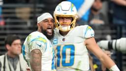 Los Angeles Chargers wide receiver Keenan Allen (13) celebrates with Los Angeles Chargers quarterback Justin Herbert (10) after scoring a touchdown against the Las Vegas Raiders during the second half at Allegiant Stadium.