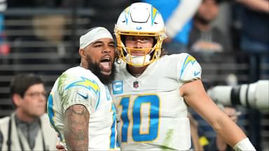 Los Angeles Chargers wide receiver Keenan Allen (13) celebrates with Los Angeles Chargers quarterback Justin Herbert (10) after scoring a touchdown against the Las Vegas Raiders during the second half at Allegiant Stadium.
