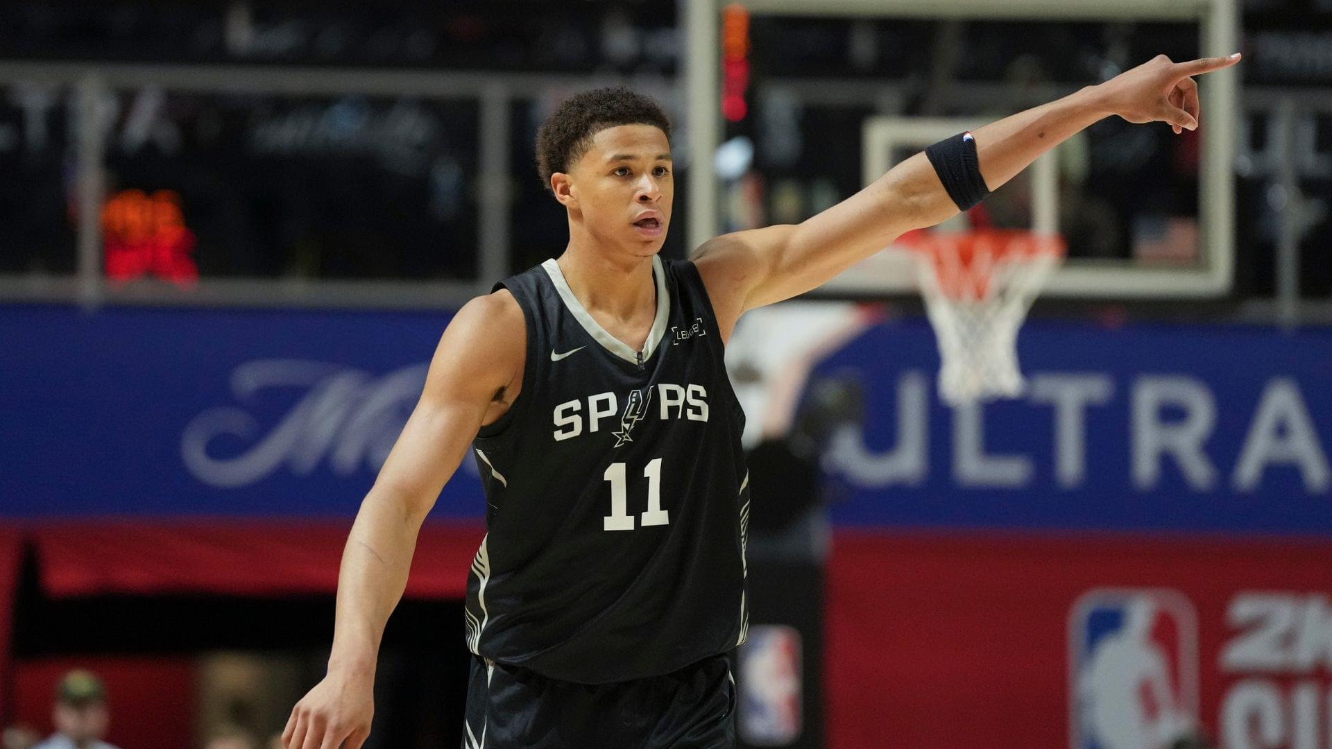 Jul 10, 2025; Las Vegas, NV, USA; San Antonio Spurs forward Carter Bryant (11) reacts to a teammates basket against the Philadelphia 76ers in the fourth quarter of their game at Thomas & Mack Center.