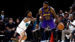 Mar 29, 2025; Memphis, Tennessee, USA; Los Angeles Lakers forward LeBron James (23) dribbles as Memphis Grizzlies guard Ja Morant (12) defends during the third quarter at FedExForum.