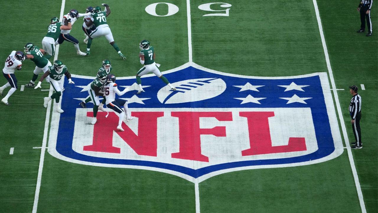 A general overall view as New York Jets quarterback Justin Fields (7) throws the ball at midfield on the NFL shield logo in the first quarter against the Denver Broncos during an NFL International Series game at Tottenham Hotspur Stadium.