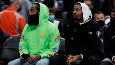 Dec 12, 2021; Detroit, Michigan, USA; Brooklyn Nets guard James Harden (left) and forward Kevin Durant (right) sit on the bench in the first half against the Detroit Pistons at Little Caesars Arena