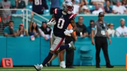 New England Patriots cornerback Christian Gonzalez (0) runs the ball for a touchdown after recovering a fumble against the Miami Dolphins during the second half at Hard Rock Stadium.