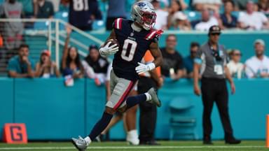New England Patriots cornerback Christian Gonzalez (0) runs the ball for a touchdown after recovering a fumble against the Miami Dolphins during the second half at Hard Rock Stadium.