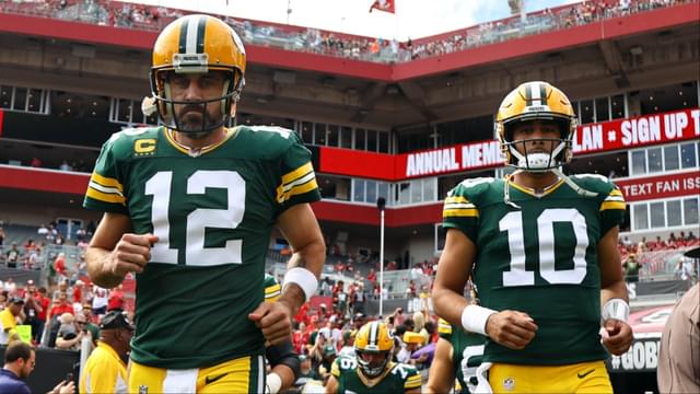Green Bay Packers quarterbacks Aaron Rodgers (12) and Jordan Love (10) run out onto the field against the Tampa Bay Buccaneers at Raymond James Stadium.