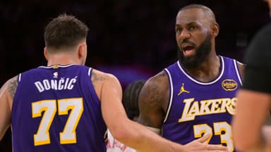 Nov 25, 2025; Los Angeles, California, USA; Los Angeles Lakers guard Luka Doncic (77) and forward LeBron James (23) react after a foul during the first half against the Los Angeles Clippers at Crypto.com Arena