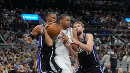 San Antonio Spurs forward Keldon Johnson (3) grabs a rebound in between Sacramento Kings guard Russell Westbrook (18) and forward Domantas Sabonis (11) in the second half at Frost Bank Center.