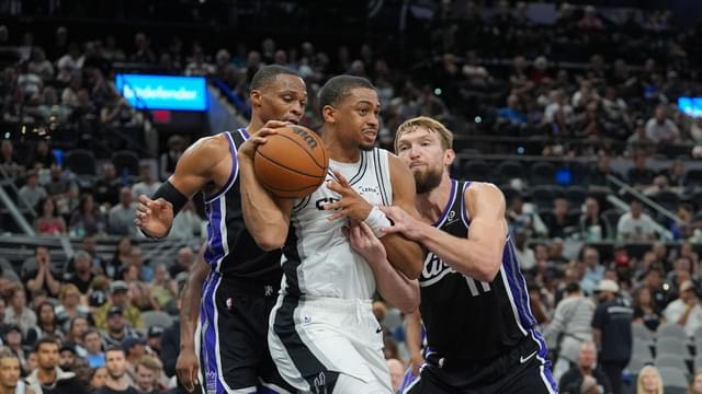 San Antonio Spurs forward Keldon Johnson (3) grabs a rebound in between Sacramento Kings guard Russell Westbrook (18) and forward Domantas Sabonis (11) in the second half at Frost Bank Center.